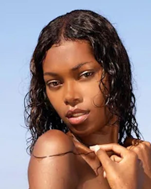 Jessica White poses before the ocean sporting wet hair.